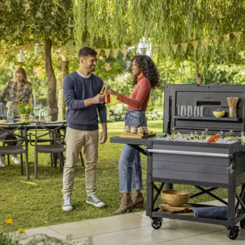 Keter 89.8 Qt Portable Outdoor Patio Cooler Ice Chest, Beverage Party Bar Cart Table with Swivel Wheels, Shelves, and Bottle Opener, Graphite